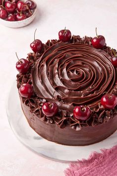 a cake with chocolate frosting and cherries on top