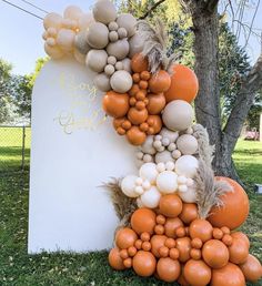 an orange and white balloon sculpture in the grass