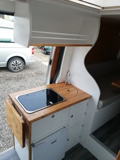 an oven and sink in the back of a small boat with wood trimmings