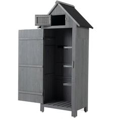 a gray wooden storage cabinet with an open door and shelves on the side, in front of a white background