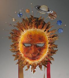 a sun face with planets around it