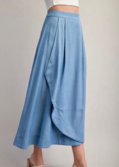 This flowing midi skirt has a high waist, front darts, front wrap detail, and side hidden in-seam zip closure. Cape Skirt, Boutique Homes, Sky Blue, Cape, Midi Skirt, High Waist, High Waisted, Boutique, Skirt