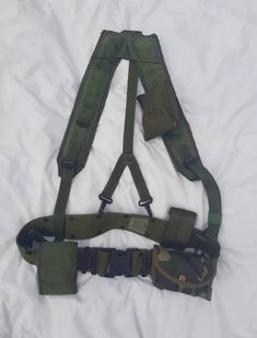 This listing is for a Military Suspender Utility Belt/Vest. In excellent used condition. No damages that I was able to find. Please see photos for detail. Military Utility Jacket With Side Pockets For Streetwear, Utility Outfit, Fantasy Utility Belt, Army Vest, Military Vest With Pockets For Streetwear, Khaki Military Vest With Side Pockets, Military Cotton Vest With Cargo Pockets, Utility Vest, Utility Belt