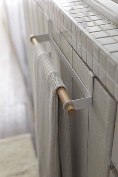 a white radiator with a wooden handle on it