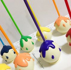 there are some cake pops with colorful icing on them