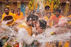 the bride and groom are splashing water on each other