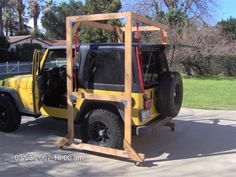 a yellow jeep with its doors open on the street