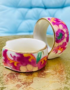 two wedding bands with flowers painted on them