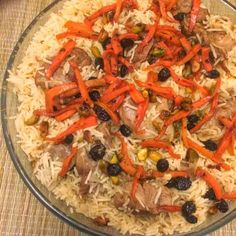 a bowl filled with rice and vegetables on top of a table