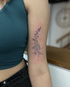 a woman with a flower tattoo on her arm