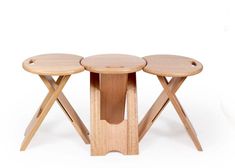 three wooden stools sitting next to each other