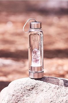 a water bottle sitting on top of a rock