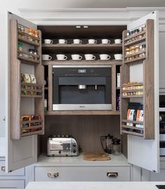 an open kitchen cabinet with a microwave and toaster