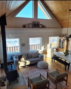 a living room filled with furniture and windows