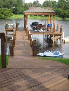 a wooden dock with boats docked at the end