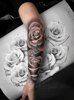 a woman's arm with roses on it