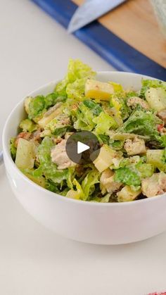 a white bowl filled with salad on top of a table