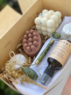 a wine bottle and some soaps are in a box with other items inside it