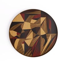 a wooden plate with abstract designs on it