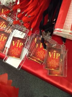 some red bags and other items on a table with silverware hanging from it's sides