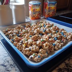 a blue tray filled with cookies and marshmallows on top of a counter