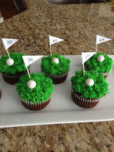 cupcakes decorated with green grass and golf flags