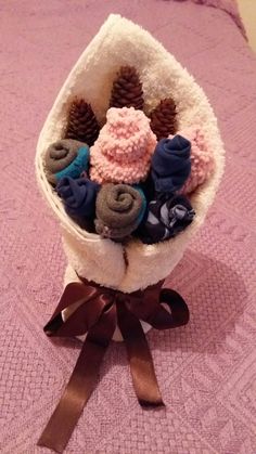 a basket filled with knitted items on top of a bed