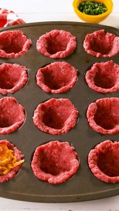 an uncooked muffin tin filled with mini meatloaf cupcakes