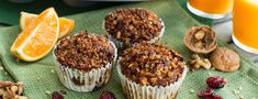 muffins with nuts, cranberries and orange slices on a green towel