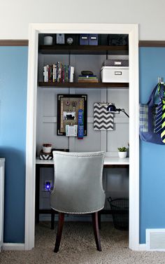 a chair sitting in front of a desk under a book shelf next to a blue wall