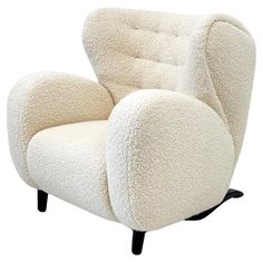 a white chair with a black base and foot rest on it's back legs