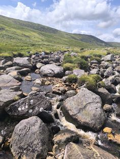 some rocks and water on the side of a hill