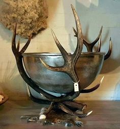 a metal bowl with antlers on it