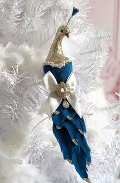 a blue and white ornament hanging from a christmas tree