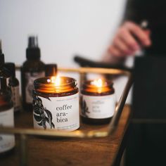 two candles sitting on top of a wooden table