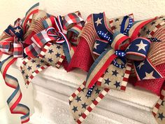 red, white and blue bows are on the mantle for fourth of july or memorial day