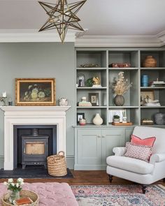 a living room filled with furniture and a fire place in the middle of a room