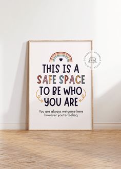 this is a safe space to be who you are poster on the wall in an empty room