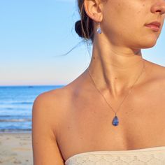 SODALITE CRYSTAL JEWELRY SET This delicate, teardrop Sodalite jewelry set is the epitome of understated beauty, making it the perfect gift for women any day of the year. The dainty blue stone necklace and earrings set is comprised of genuine indigo blue Sodalite stones. Choose either Sterling Silver 925 or 14K Gold fill as your finish. Also choose your necklace chain length: 16 inches, 18 inches or 20 inches. Please note that every Sodalite stone will vary in blue color and some will have white  striations, making each teardrop pendant beautifully unique.  The small and lightweight Sodalite stones are set in a lovely teardrop shape and are expertly wire wrapped by hand. The lightweight stone suspends 2 cm, about the height of a dime. The stone measures 1 cm at its widest point.  The chain Blue Pear-shaped Birthstone Jewelry, Wire Wrapped Drop Jewelry For Party, Blue Briolette Teardrop Earrings For Gift, Wire Wrapped Teardrop Jewelry For Parties, Blue Teardrop Jewelry With Matching Earrings, Blue Teardrop Necklace With Matching Earrings, Teardrop Wire Wrapped Jewelry For Party, Drop Necklaces With Matching Earrings As Gift, Drop Necklaces With Matching Earrings For Gift