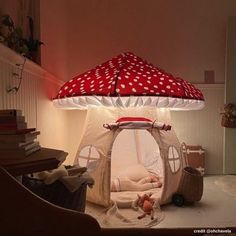 a child's bed with a red and white polka dot dome light on top