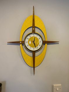 a clock that is on the side of a wall with a yellow circle around it