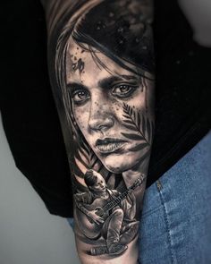 a woman's arm with a black and white tattoo on it