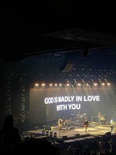 an image of people on stage with the words god is madly in love with you