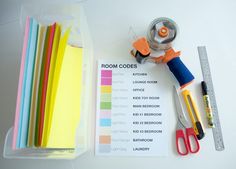 some crafting supplies are sitting on a table next to a ruler, scissors and paper