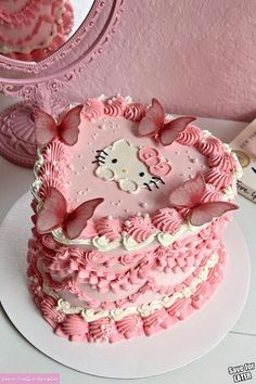 a hello kitty cake with pink frosting and flowers