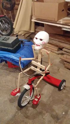 a wooden toy bike with a face on it