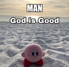 a pink stuffed animal sitting on top of a sandy beach with the words man god is good above it