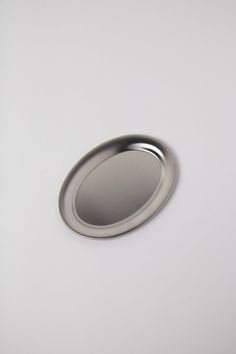 a round metal object on a white surface