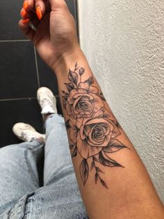 a person with a flower tattoo on their arm