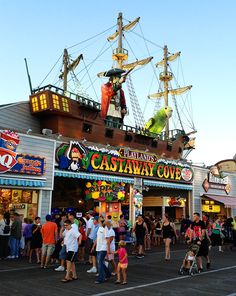 many people are walking around in front of a carnival